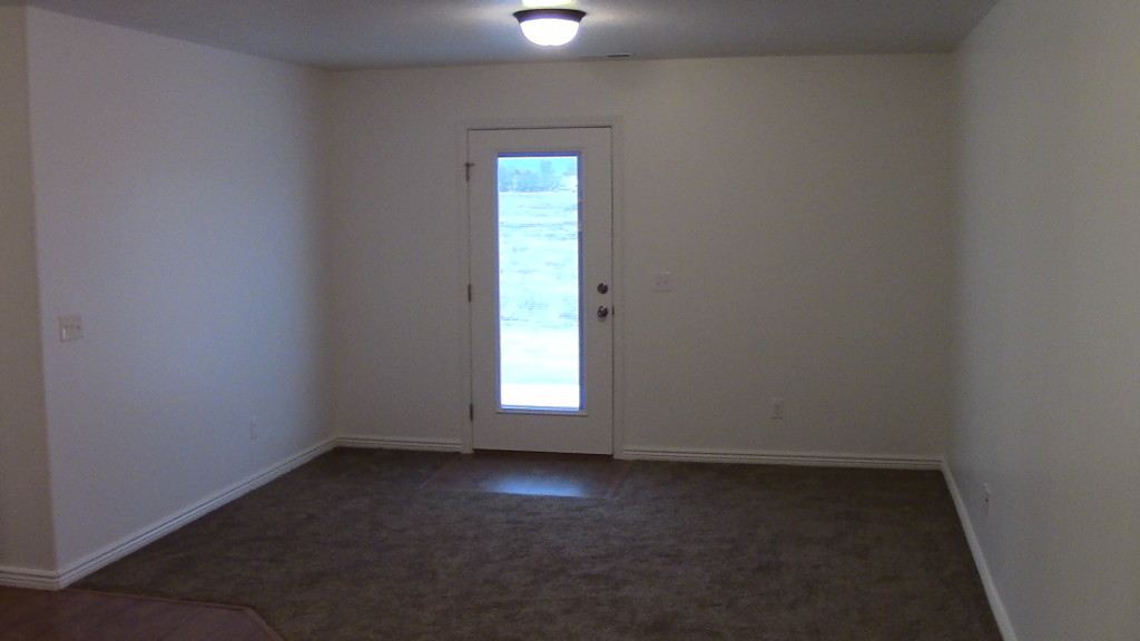 Picture of Dining/Living area and back door. 