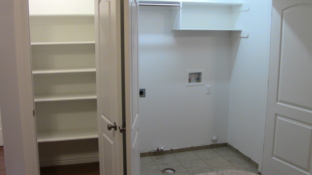 Picture of Closet/Pantry with built-in shelves and the closet next to it with Washer and dryer hook-ups