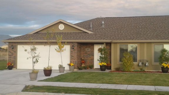 Front of 2877. Shows 2 car garage, front door and window.